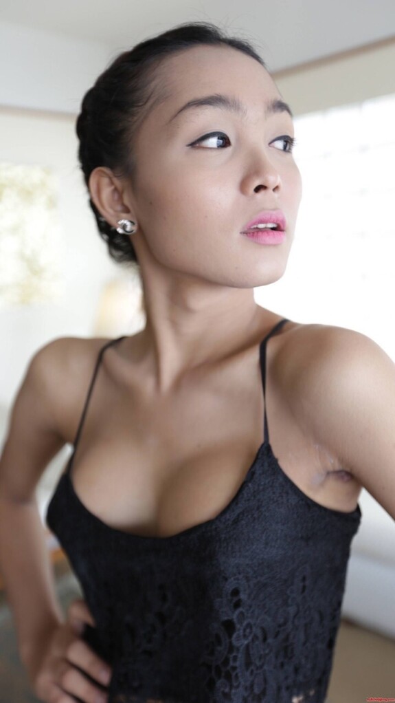 Pretty Asian shemale shows her tiny tits while teasing in a sexy black dress