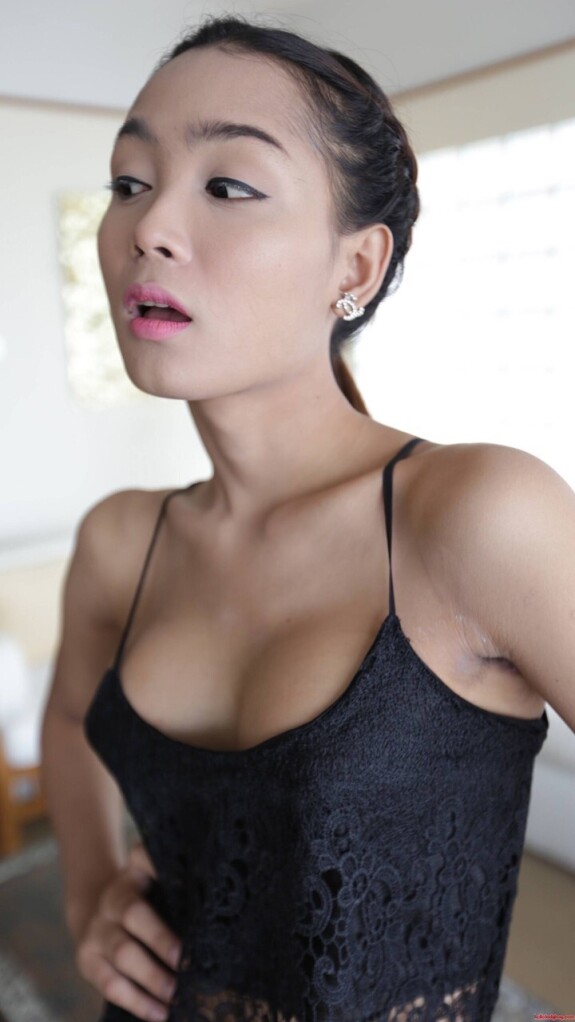 Pretty Asian shemale shows her tiny tits while teasing in a sexy black dress