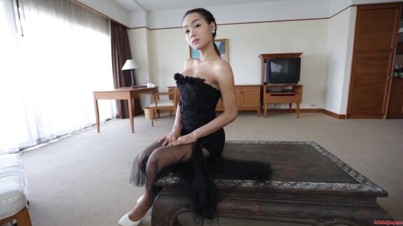 Pretty Asian shemale shows her tiny tits while teasing in a sexy black dress