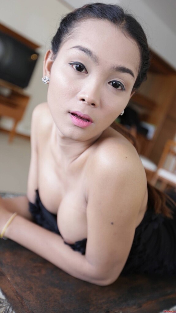 Pretty Asian shemale shows her tiny tits while teasing in a sexy black dress