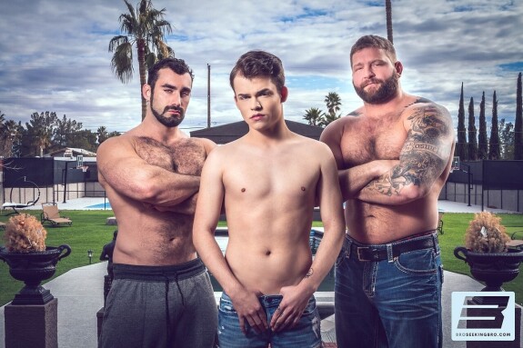 Muscular gay men spit roast a hot twink in a wild anal threesome