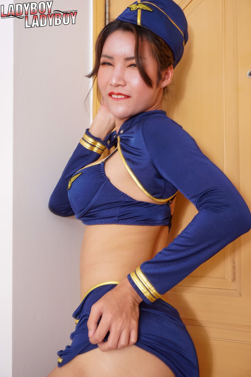 Asian shemale Emmy strips off her stewardess uniform and masturbates