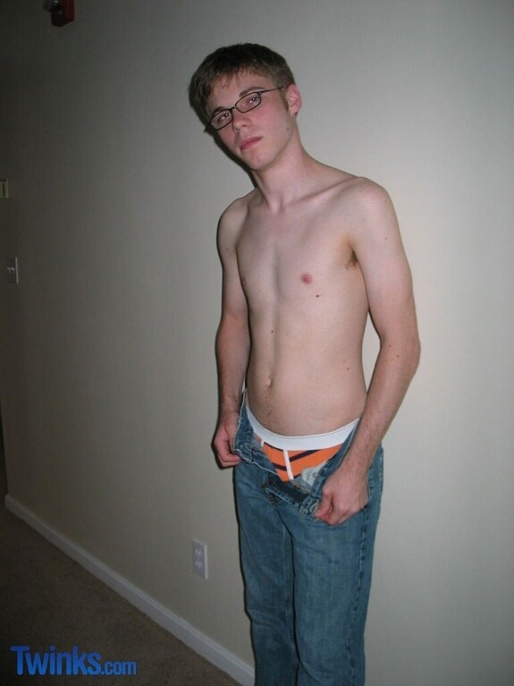 Nerdy twink Billy Gee loses his shirt and jeans and jerks off his massive dick