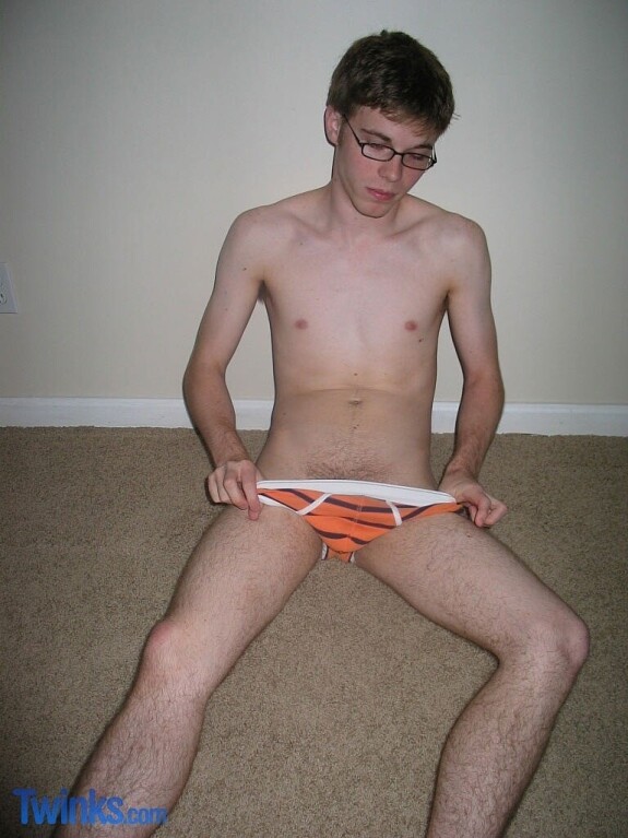 Nerdy twink Billy Gee loses his shirt and jeans and jerks off his massive dick