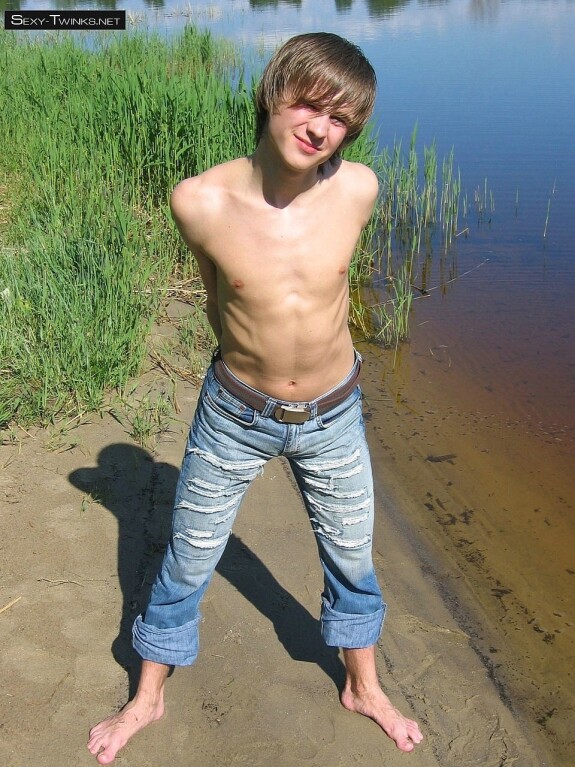 Gay beauty Mike strips by the river and plays with his hard dick