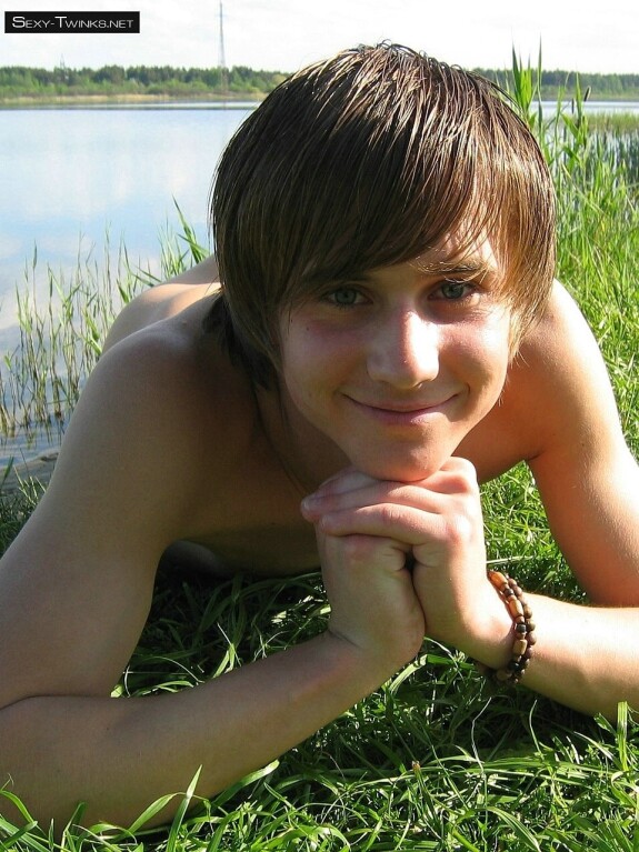 Gay beauty Mike strips by the river and plays with his hard dick