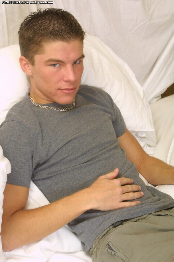 Kinky gay Nick doffs his shirt and pants and masturbates on a bed