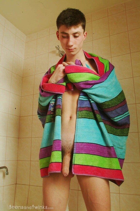 Petite skinny twink doffs his clothes and gets wet in a foamy bathtub