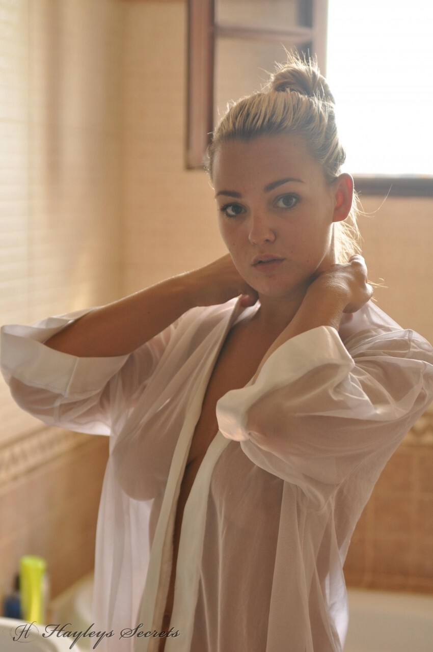 Beautiful blonde chick Jodie Gasson pulls on a see thru blouse in the morning