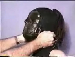 Perverted grasp is protecting his slave's face with a mask