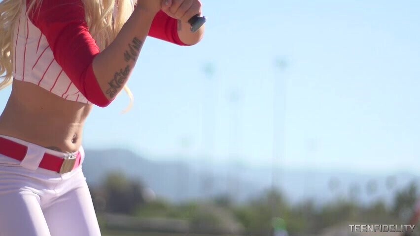 Ultra narrow sporty blonde is posing in a baseball outfit