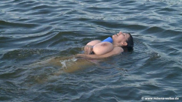 Dark-haired MILF enjoys being topless withinside the ocean