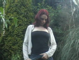 Exotic redhead chick flashes her adorable pussy withinside the garden