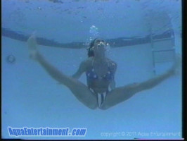 Beautiful smiling brunette dances underwater with passion