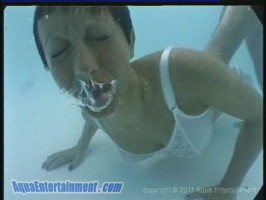 Slender female is getting absolutely bare underwater and displaying her knockers