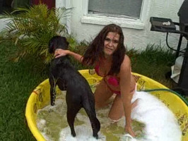 The sexiest massive-boobed youngsterager gf bathes her canine in outside pool