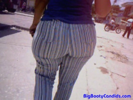 Just filming how a horny huge booty babe in striped pants is taking walks on the road