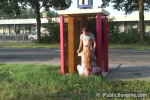 Slender redhead slut is sucking a tough wiener on public