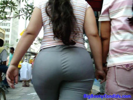 Dark-haired female with large butt and tight gray pants