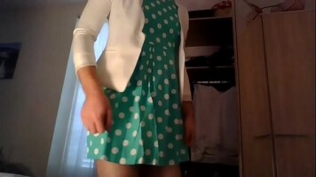 Amateur cross dresser in a cute polkadots dress and a sexy white blazer home after work