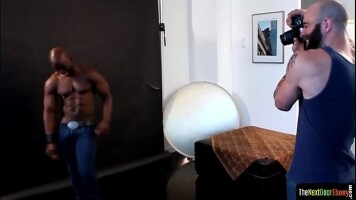 Ebony hunk sucks cock during photo session