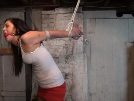 Skirt-carrying brunette indicates off her frame in a bondage scene