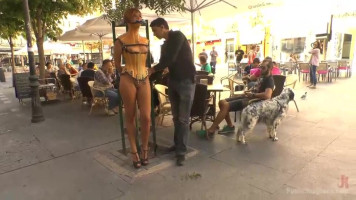 Blindfolded latex doll humiliated on town principal street