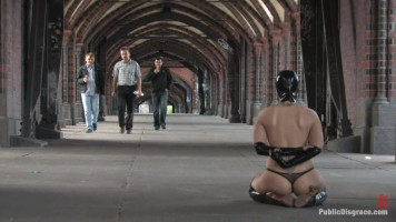 Masked MILF whore sitting on her knees all bare in public