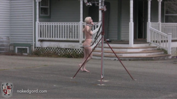 Naked slut is compelled to stroll in circles outdoors