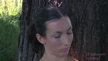 Girl is getting tied to a tree with the aid of using a domme in black get dressed